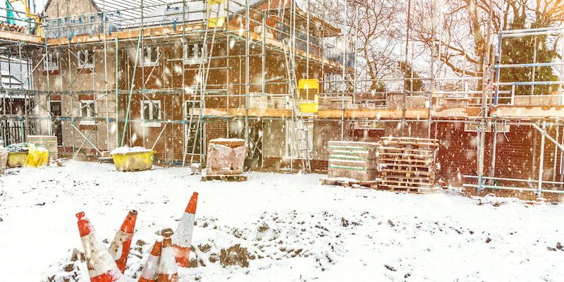 Construction site with snow on the ground